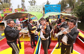 Tourists ride "trajineras" through canals of Xochimilco in Mexico City